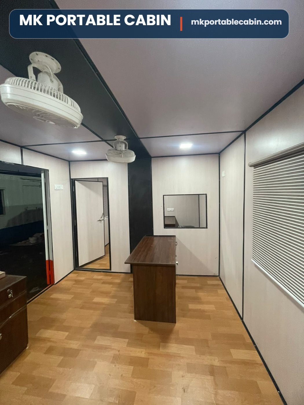 Workstation table inside 20 x 10 portable office cabin with PVC panelling