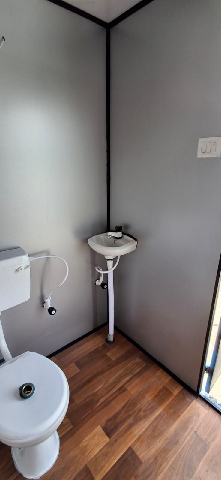 Wash basin inside a toilet cabin by MK Portable Cabin